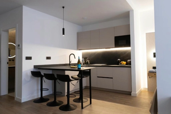 Cocina moderna con barra americana y taburetes en Alma Demetrio – Puerto de Valencia.