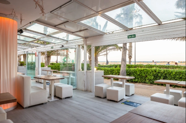 Terraza acristalada del restaurante Destino 56 en primera línea de la Playa de las Arenas en Valencia.