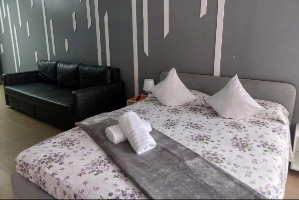 Habitación doble con sofá en hostal de Poblados Marítimos Valencia